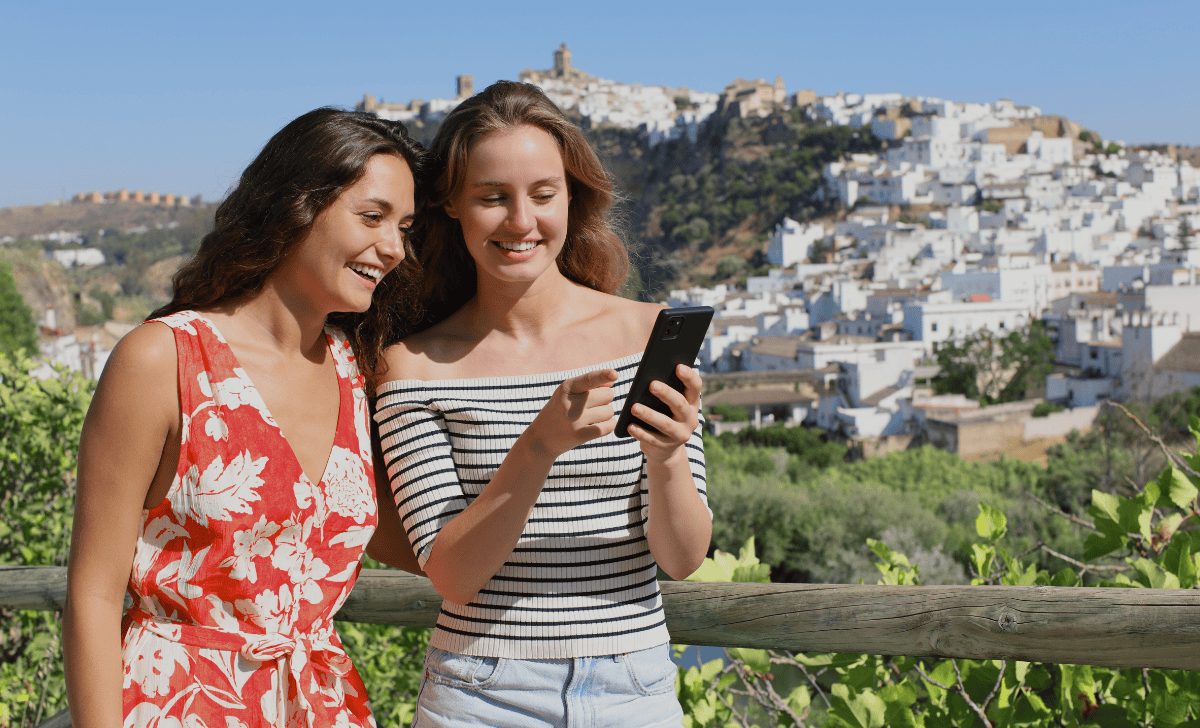 2 Women looking at a phone.