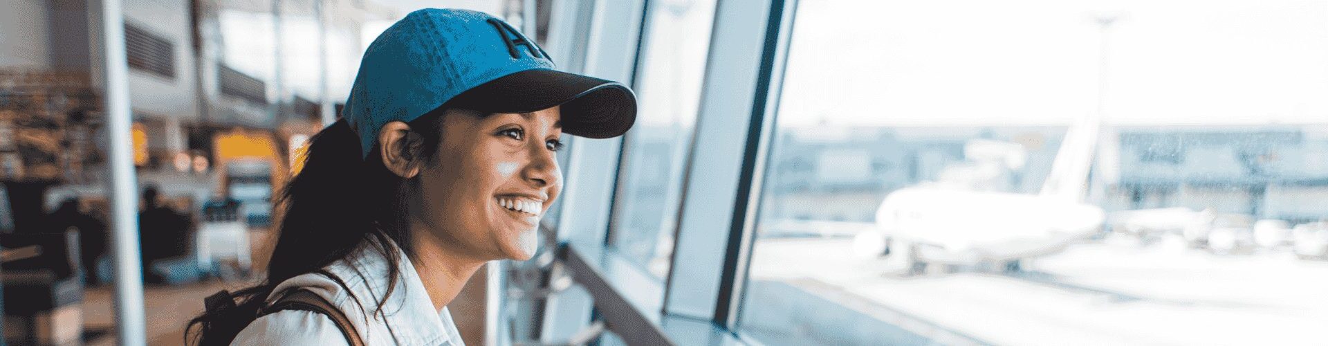 girl looking through airport window